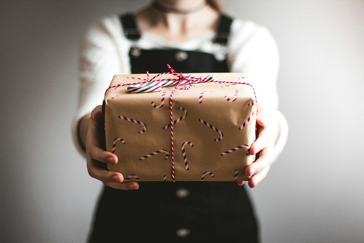 Person holding gift-wrapped present